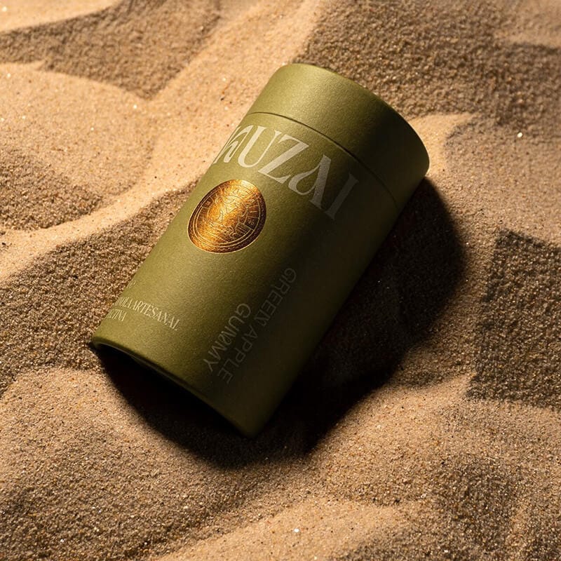 a cardboard tube edibles packaging on the beach