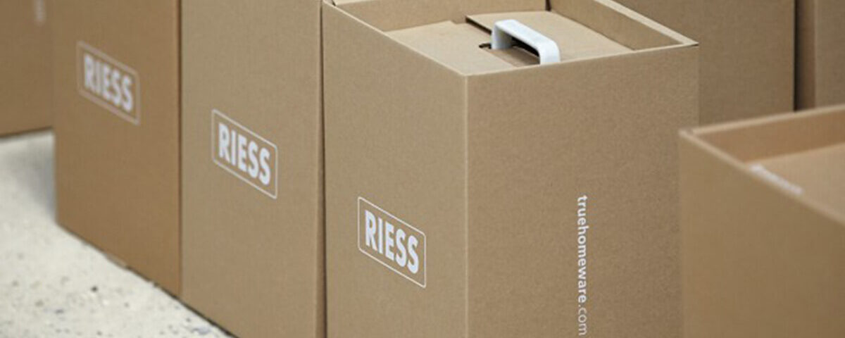 Custom kraft boxes stacked neatly with a branded logo, showcasing a clean and minimal design.