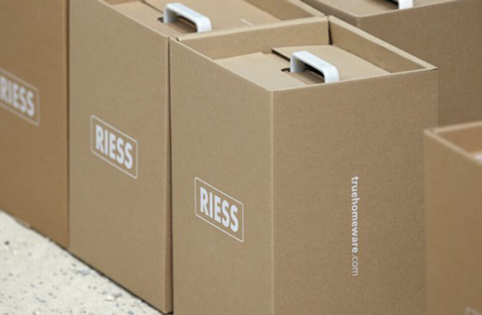 Custom kraft boxes stacked neatly with a branded logo, showcasing a clean and minimal design.