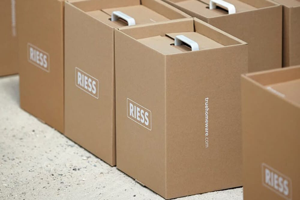 Custom kraft boxes stacked neatly with a branded logo, showcasing a clean and minimal design.