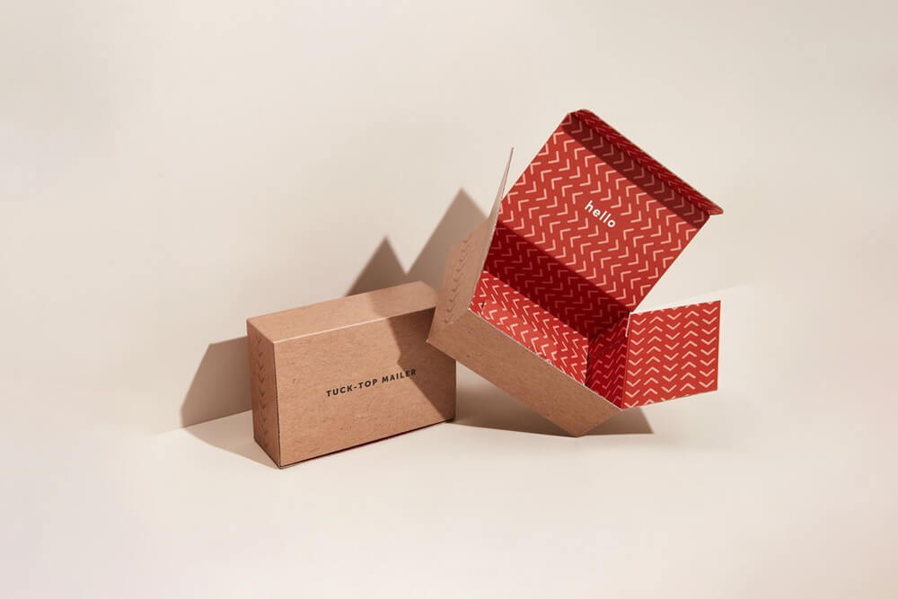 Custom kraft mailer box with a red interior, showcasing the tuck-top style.