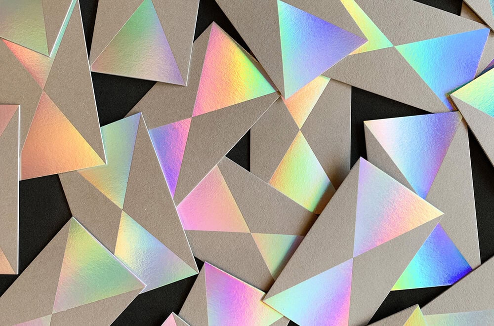 a group of paper envelopes made of holographic paper
