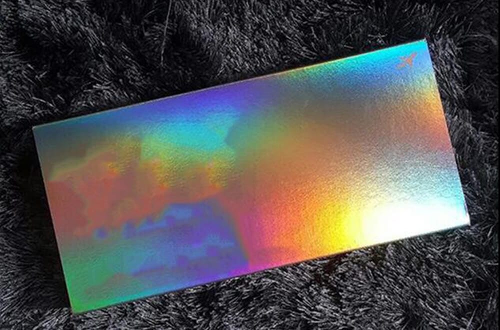 a piece of holographic paper showing different color with a 3D effect