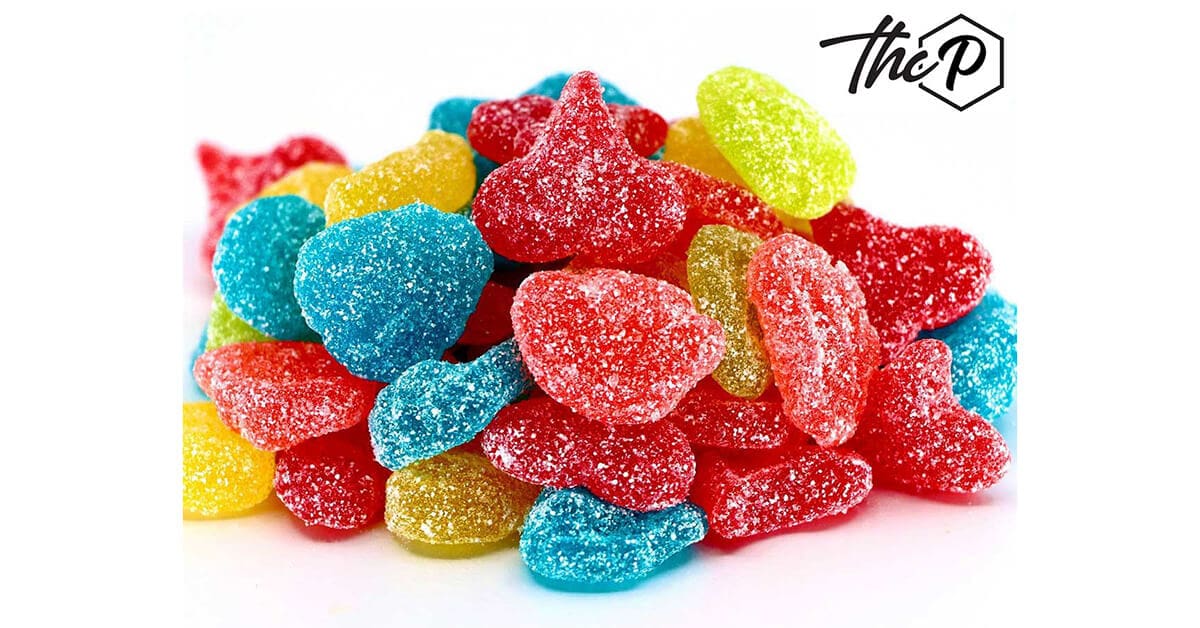 Brightly colored sour THCP gummies in red, yellow, blue, and green