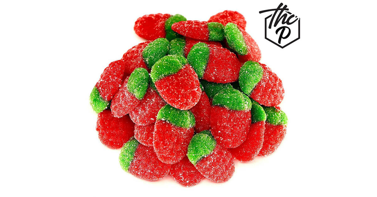 Strawberry-shaped THCP gummies with red and green sugar coating
