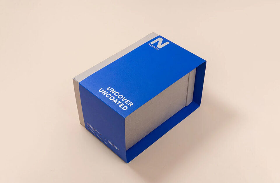 Blue and silver uncoated cardboard sleeve packaging box with bold branding