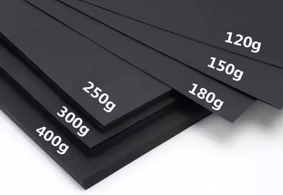 several pieces of paper sheets showing different thickness of black kraft paper