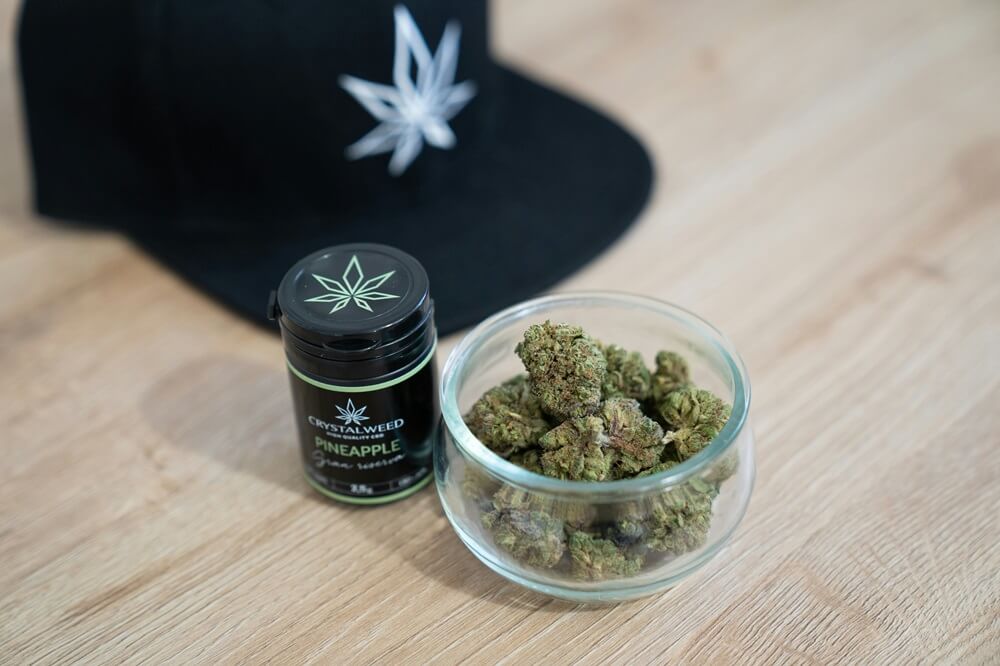 Crystalweed cannabis concentrate packaging with branded jar and dried flower