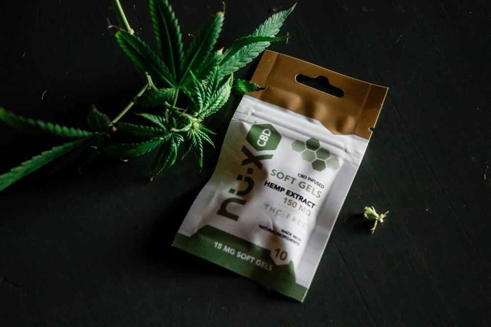 nu-x CBD soft gel pouch and hemp leaves for cannabis concentrate packaging