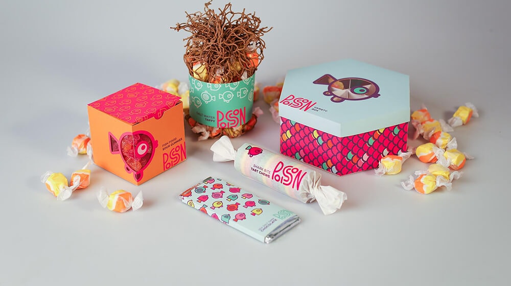 a hexagon gift box and a tuck end gift box put aside with some candies