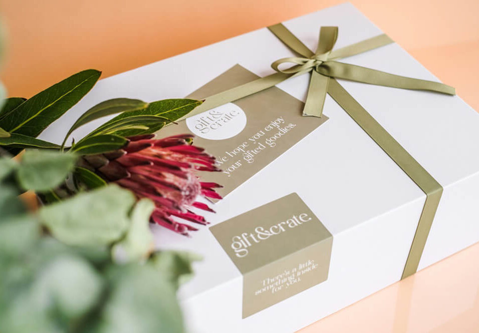 Elegant white gift box with ribbon and flower arrangement for cannabis packaging