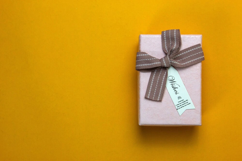 Pink gift box with ribbon and tag ideal for feminine cannabis gift packaging
