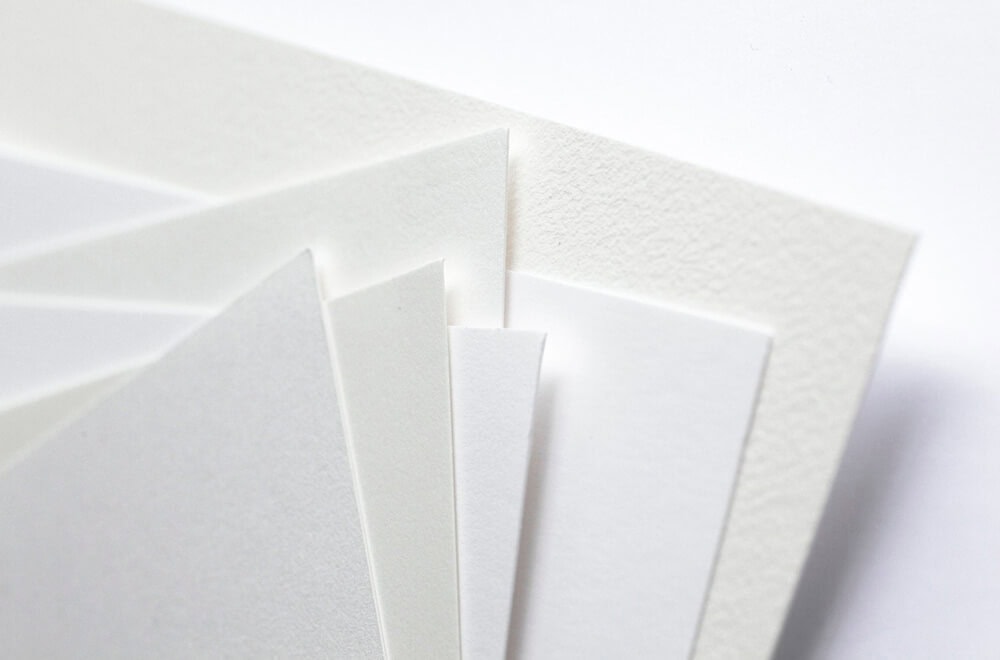 a pile of paper sheets showing different paper texture