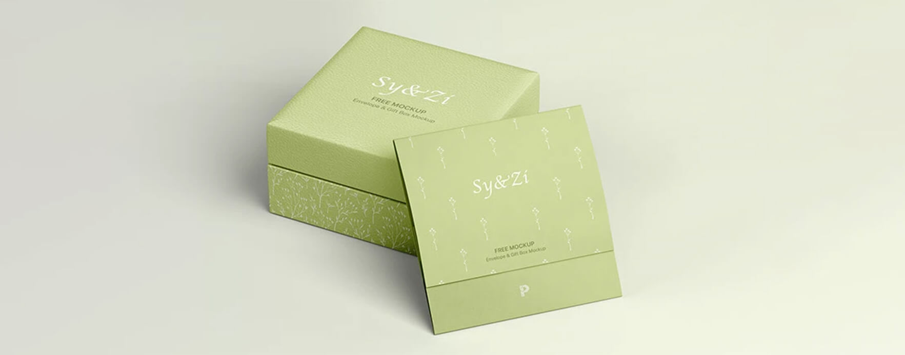 a luxurious ring box made with textured paper and printed with light green put aside with a light green paper card