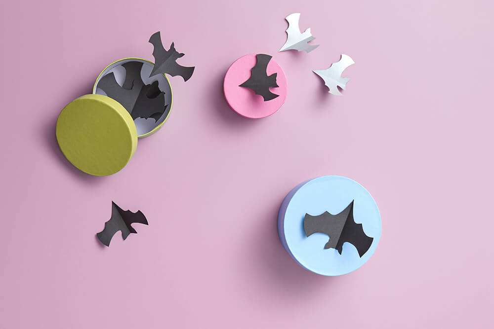 Person working in a packaging warehouse with parcels and a computer