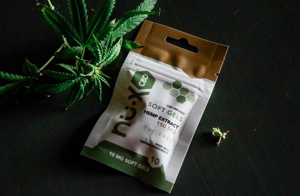 CBD soft gels exotic weed bags with cannabis leaf on black background