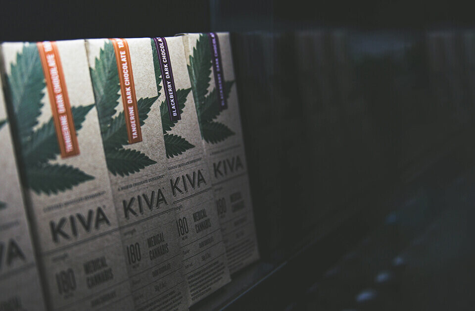 Kiva weed chocolate bars with cannabis leaf branding displayed on a retail shelf