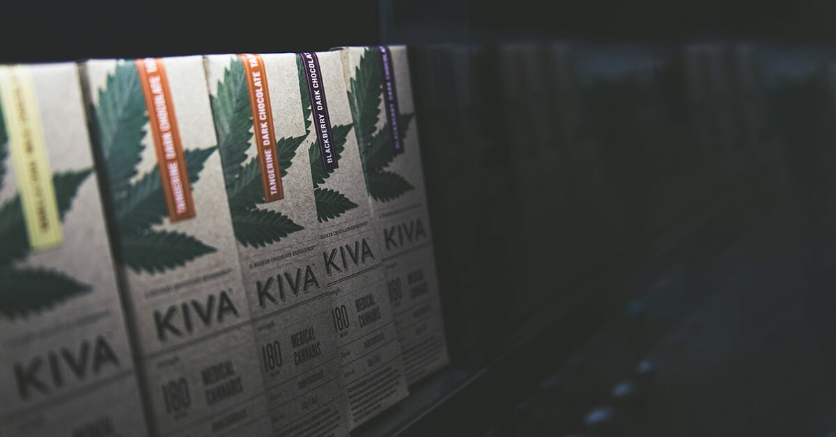 Kiva weed chocolate bars with cannabis leaf branding displayed on a retail shelf