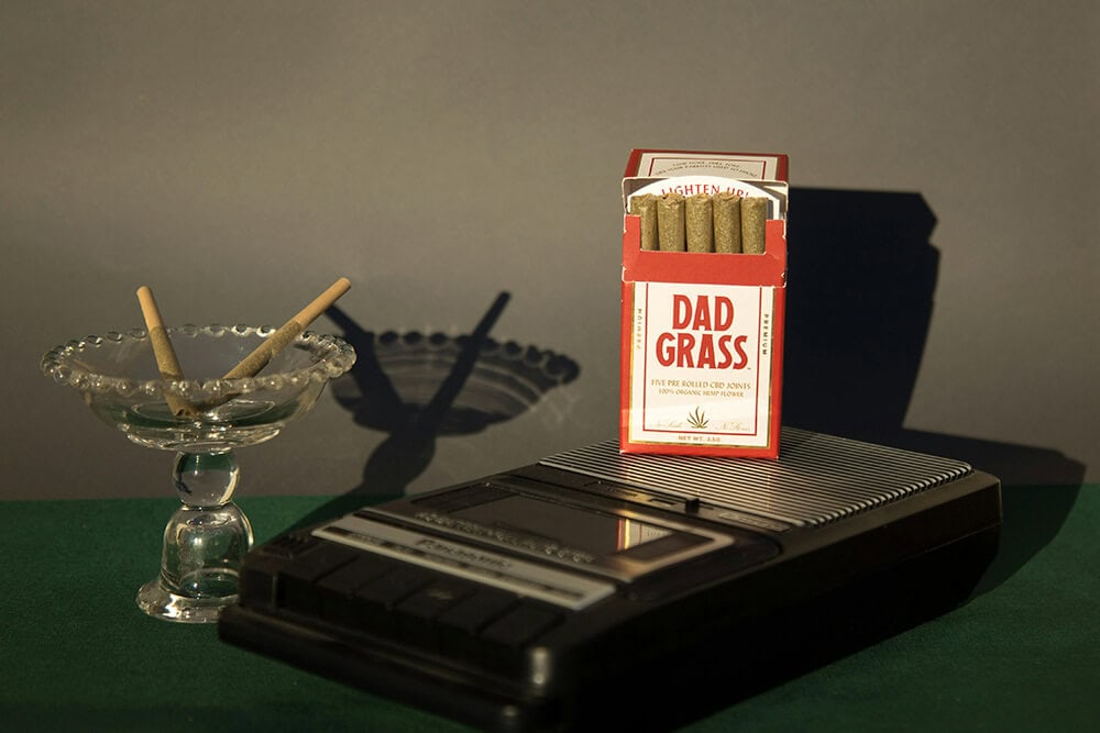 Dad Grass pre-rolled CBD joints with vintage tape recorder and ashtray