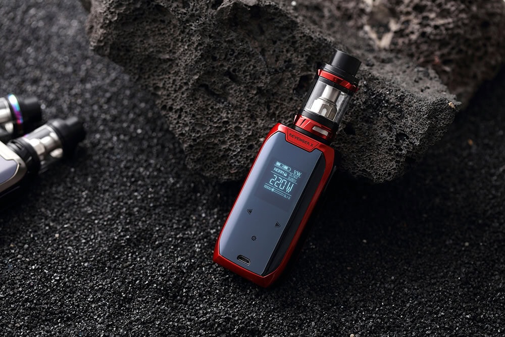 High-tech red vape device placed on black sand and volcanic rock