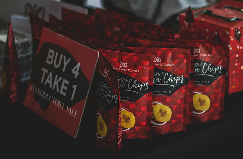 custom packaging services: red custom food packaging pouch for banana chips with promotional display