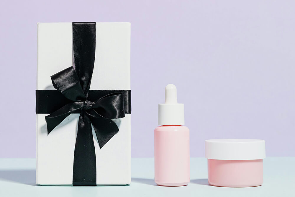 Custom cosmetic packaging with white gift box and black ribbon.