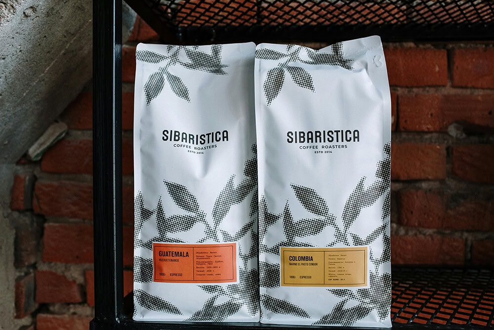 Custom printed coffee packaging bags with branded labels.