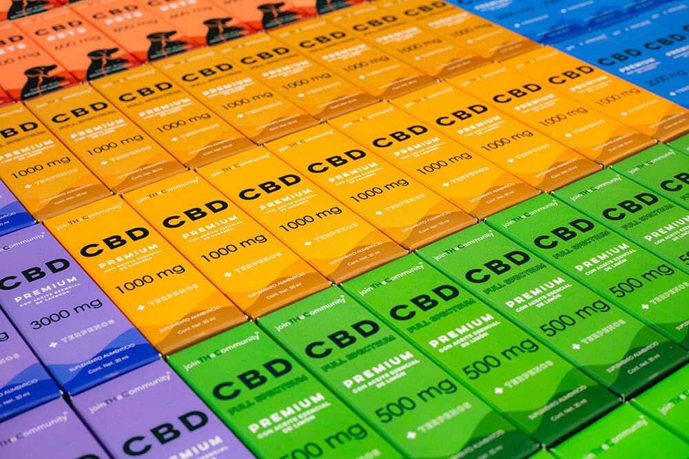 Colorful CBD product packaging boxes arranged in rows.