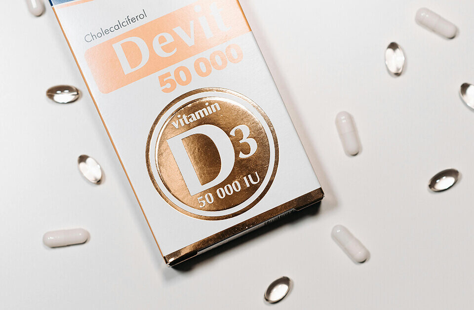 Vitamin D3 50,000 IU supplement pharmaceutical packaging design box with capsules.