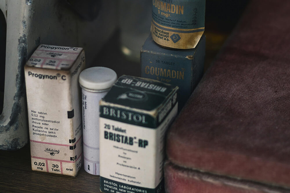 Collection of vintage pharmaceutical packaging boxes for tablets.