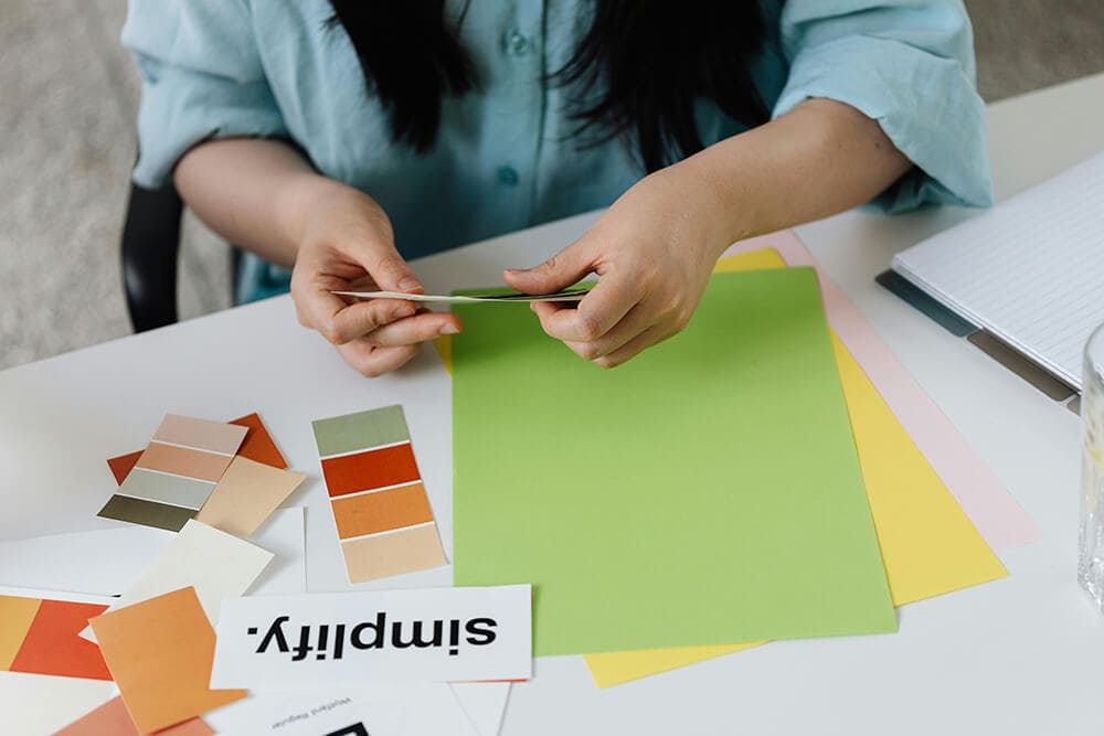 Designer choosing color palettes for RGB and CMYK printing projects