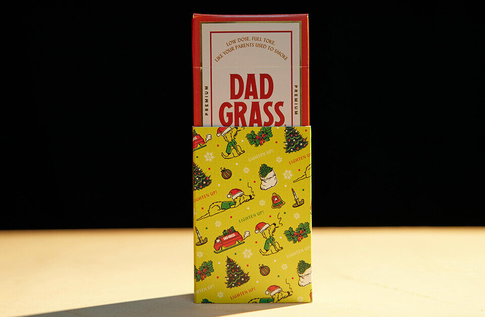 cannabis Holiday packaging with Dad Grass pre-roll pack in festive sleeve