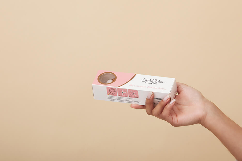 Hand holding LightWear skincare product with minimalist packaging design.