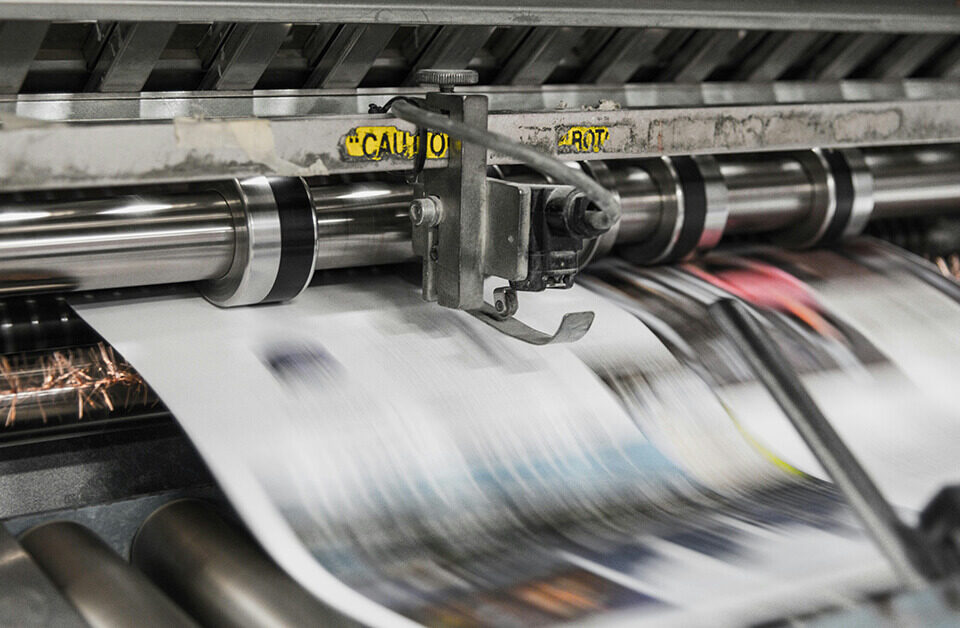 Industrial offset printing press producing high-volume packaging materials.