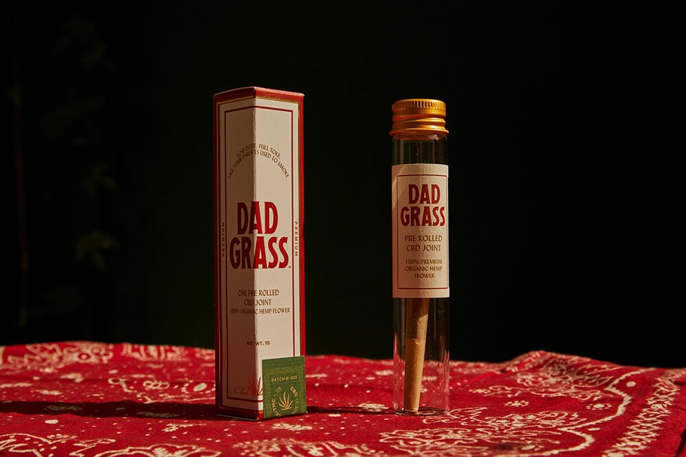 Dad Grass pre-rolled CBD joint with custom tube and box packaging