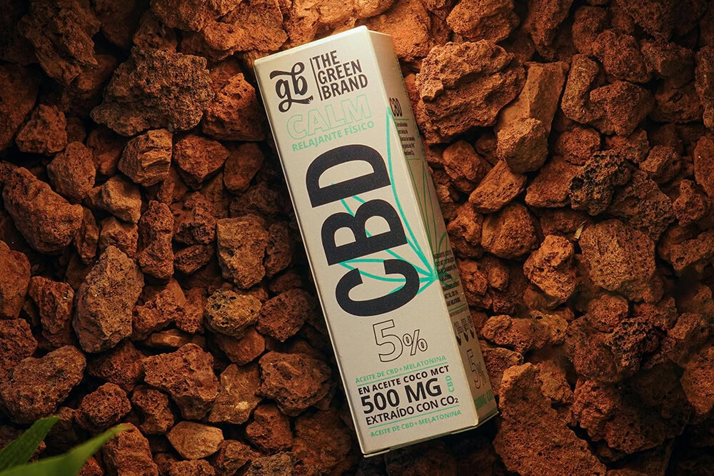 CBD oil box packaging on a natural stone background