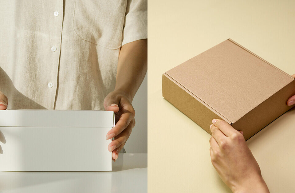 Brown and white kraft box packaging comparison held by hands