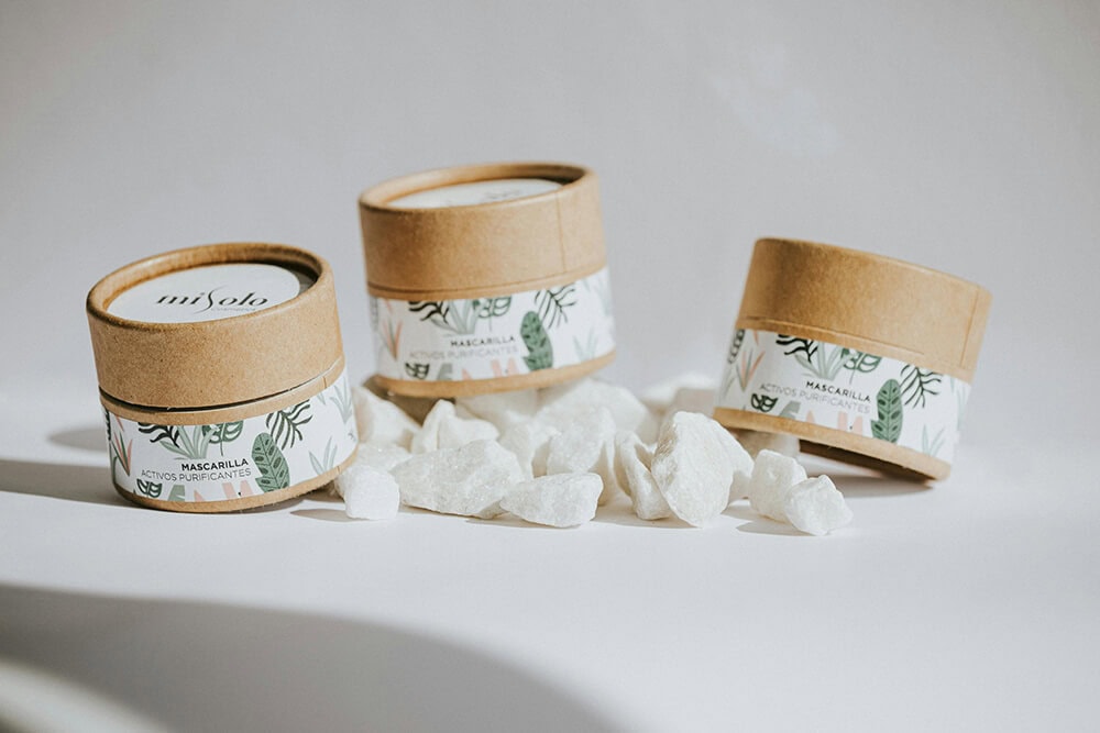 Eco-friendly kraft paper jar packaging with botanical labels.