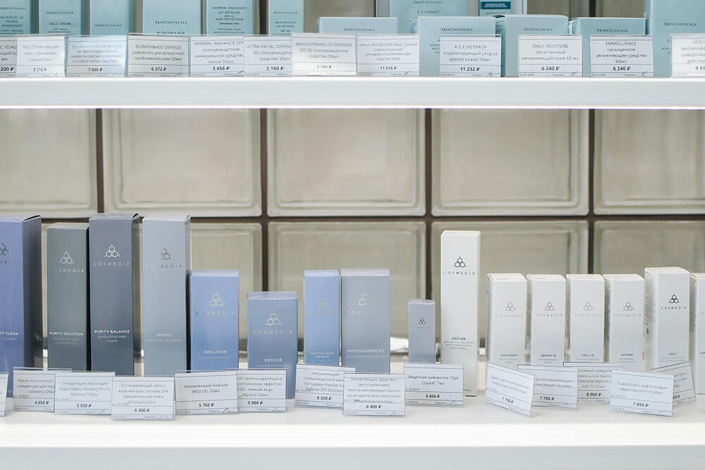 Cosmedix skincare packaging boxes organized across retail display shelves.