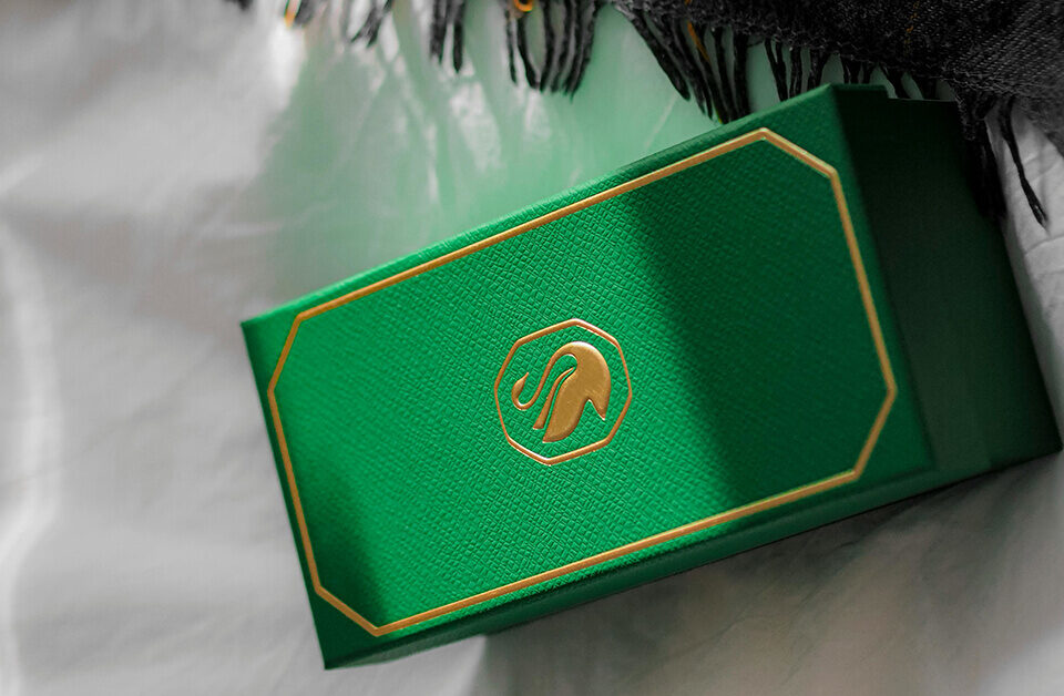 Premium green custom gift boxes with logo embossed, ideal for luxury branding.