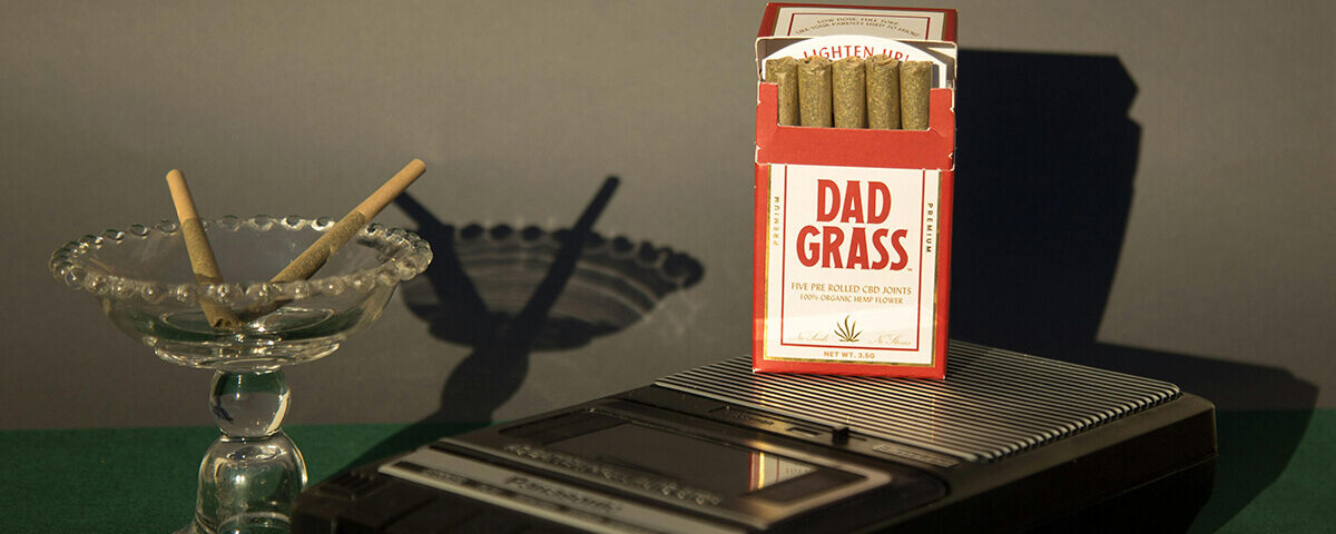 Pre-rolls displayed in branded Dad Grass folding boxes with vintage-style design.