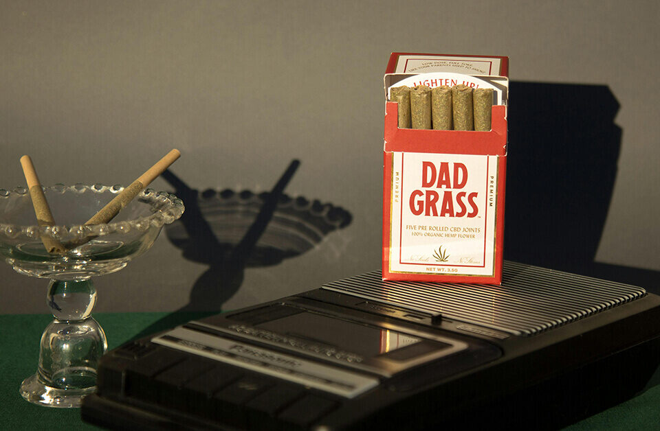 Pre-rolls displayed in branded Dad Grass folding boxes with vintage-style design.