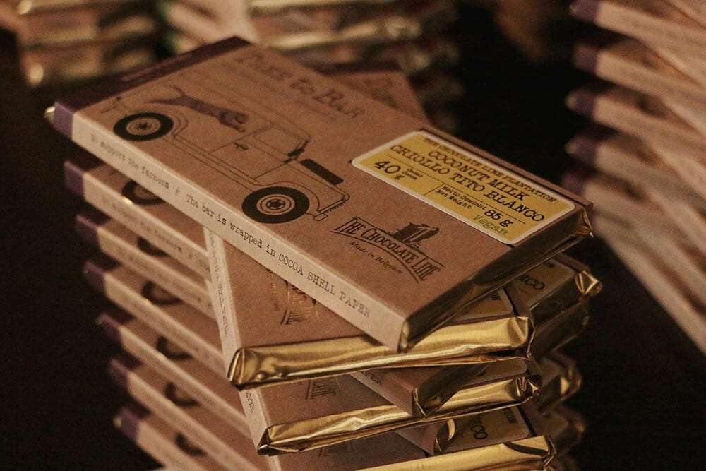 Minimalist chocolate bar packaging stacked with kraft paper wrapping.