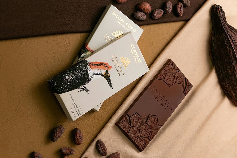Artistic chocolate bar packaging with illustrated paper wrappers and premium design.