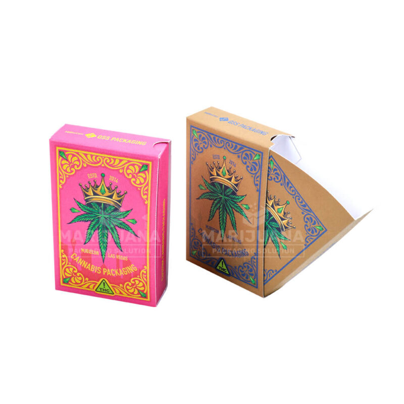 A vibrant pink pre-roll dispenser box featuring gold foil accents, a crown, and a cannabis leaf design, showcasing its premium aesthetic.