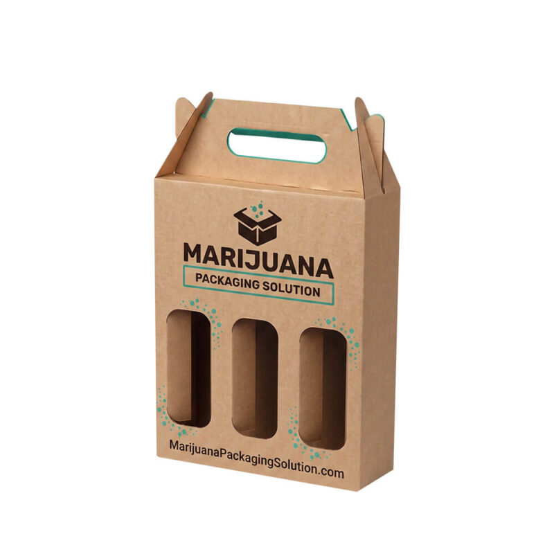 An angled three-quarter view of a vertical kraft paper 3-bottle carrier box with a prominent Marijuana Packaging Solution logo and a teal internal liner. It features a die-cut handle and three die-cut windows, with green water splash graphics.
